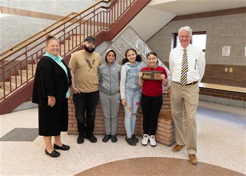 Imani Smith, Diehl Elementary's April Stairclimber, poses with her plaque, family members and Principal Sabol.