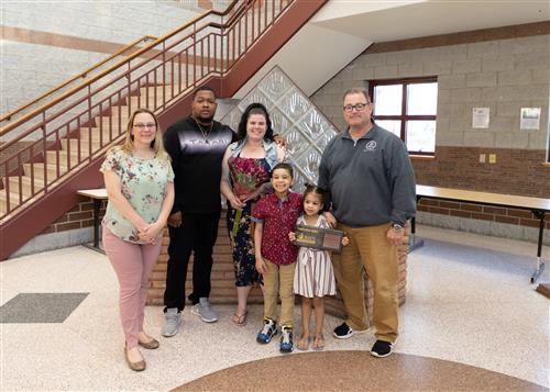 Gabriella Gayle, McKinley Elementary School's April Stairclimber, poses with her plaque, family members and Principal Suppa.