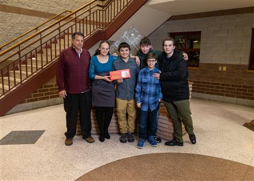 Photo of Wilson Stairclimber Eddie Tavera, family members, and Principal Mike Pisano.