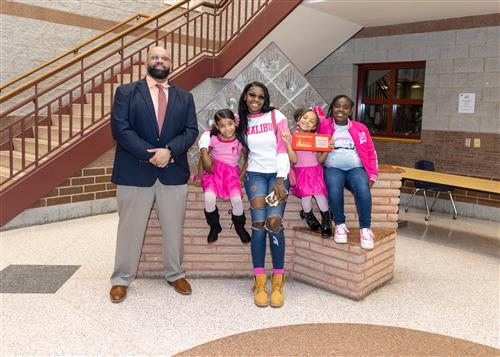 Ava'lise Stovall, February Stairclimber for Eagle's Nest, poses with her plaque, family members, and Mr. Ken Nickson.