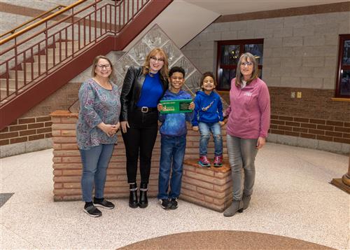 Photo of Lincoln's March Stairclimber, Maquil Randall, and family.