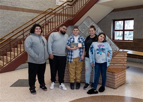 Jasen Bolorin, Wilson Middle School's April Stairclimber, poses with his plaque and family members.