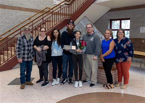 Jordyanna Estrada, McKinley Elementary's April Stairclimber, poses with her plaque, family members and school staff.