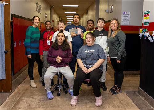 Jaylen "J.J." Mook Medina, Strong Vincent's April Stairclimber, poses with his plaque with classmates and school staff.