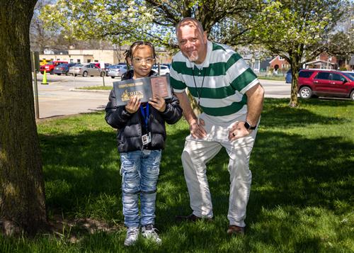 Mariano Dominick, Harding Elementary's April Stairclimber, poses with his plaque and Assistant Principal Jeff Yonkers.