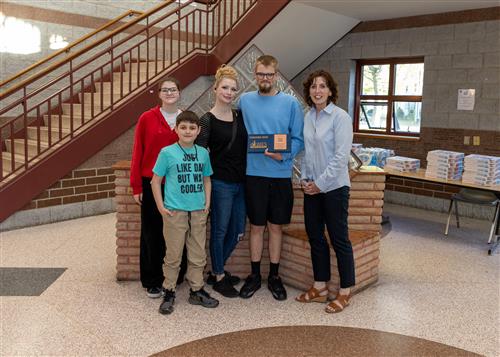 Zane Keith, Emerson-Gridley's May Stairclimber, poses with his plaque, family members, and Principal Jill Crable.