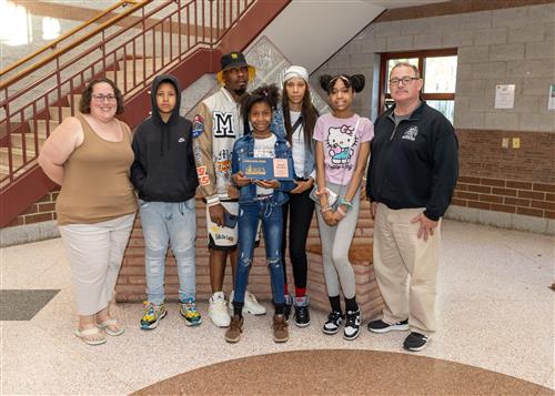 KiArah Hansbrew, McKinley's May Stairclimber, poses with her plaque, family members, and school staff.