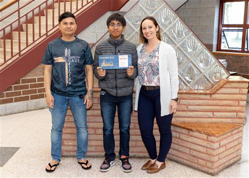 Terry Chan, Wilson Middle School's May Stairclimber, poses with his plaque, a family member and Assistant Principal Wright.