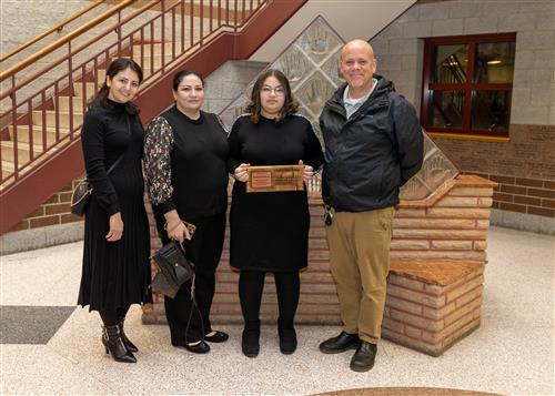 Safeya Aladinova, Harding's November 2022 Stairclimber, with family and Asst. Principal Jeff Yonkers.