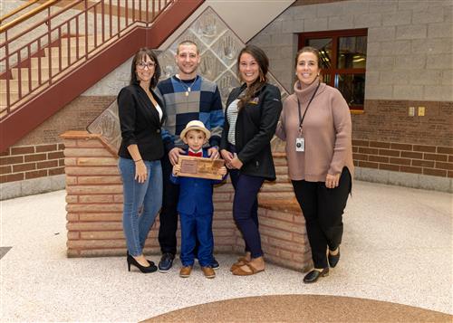 Lincoln Start, Edison's 2022 Stairclimber, posing with family members, Principal Sutton and Asst. Principal Kloss.