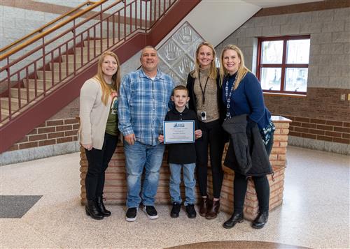 Photo of Kayden Gomez, family, and Grover Cleveland administration and faculty members.