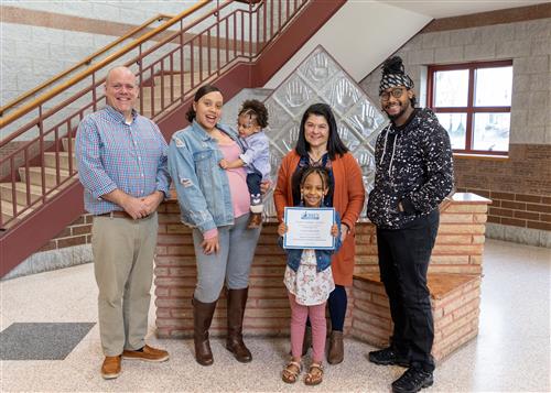 Photo of Luna Edwards, family members, and Assistant Principal Jeff Yonkers