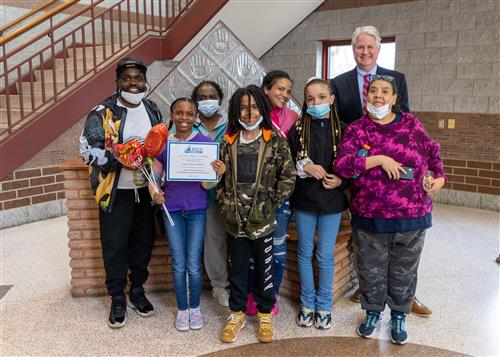 Photo of Qwaniece Jones, family members, and Diel Principal Tim Sabol.