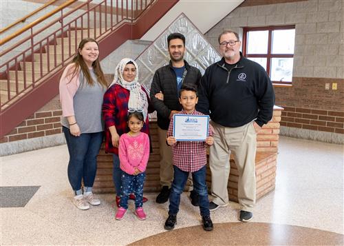 Photo of Qaisrahman Razaqi, family members, and McKinley staff.