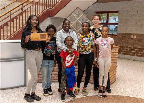 Daeonna Hemphill, the Patrick J. DiPaolo Student Success Center's October 2022 Stairclimber, posing w/ family & Jill Crable