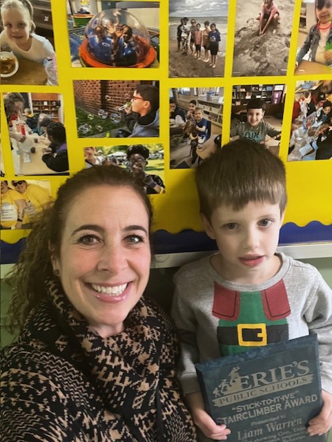 Liam Warren, Edison Elementary's December Stairclimber, poses with his plaque and Principal Diane Sutton.