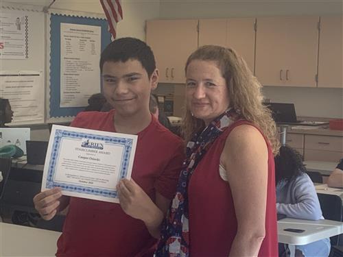 Cooper Osiecki, DiPaolo SSC's Stairclimber for October, poses with his award plaque.