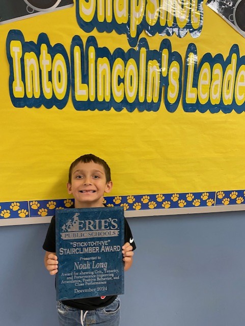 Noah Long, Lincoln Elementary's December Stairclimber, poses with his award plaque.