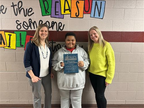 Jermaine Spruill, McKinley's December Stairclimber, poses with his plaque and school staff.