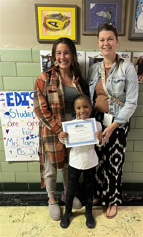 Taliona Wright, Edison's Stairclimber for October, poses with his award plaque.