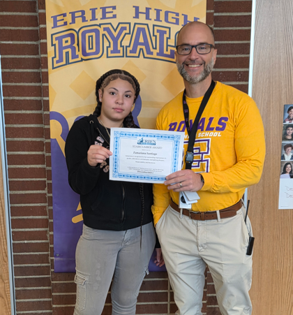 Zamariona Santiago, Erie High's Stairclimber for December, poses with his award plaque.