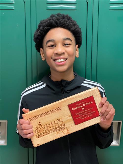 DeShawn Roberts, Jr., showing off his Stairclimber award.