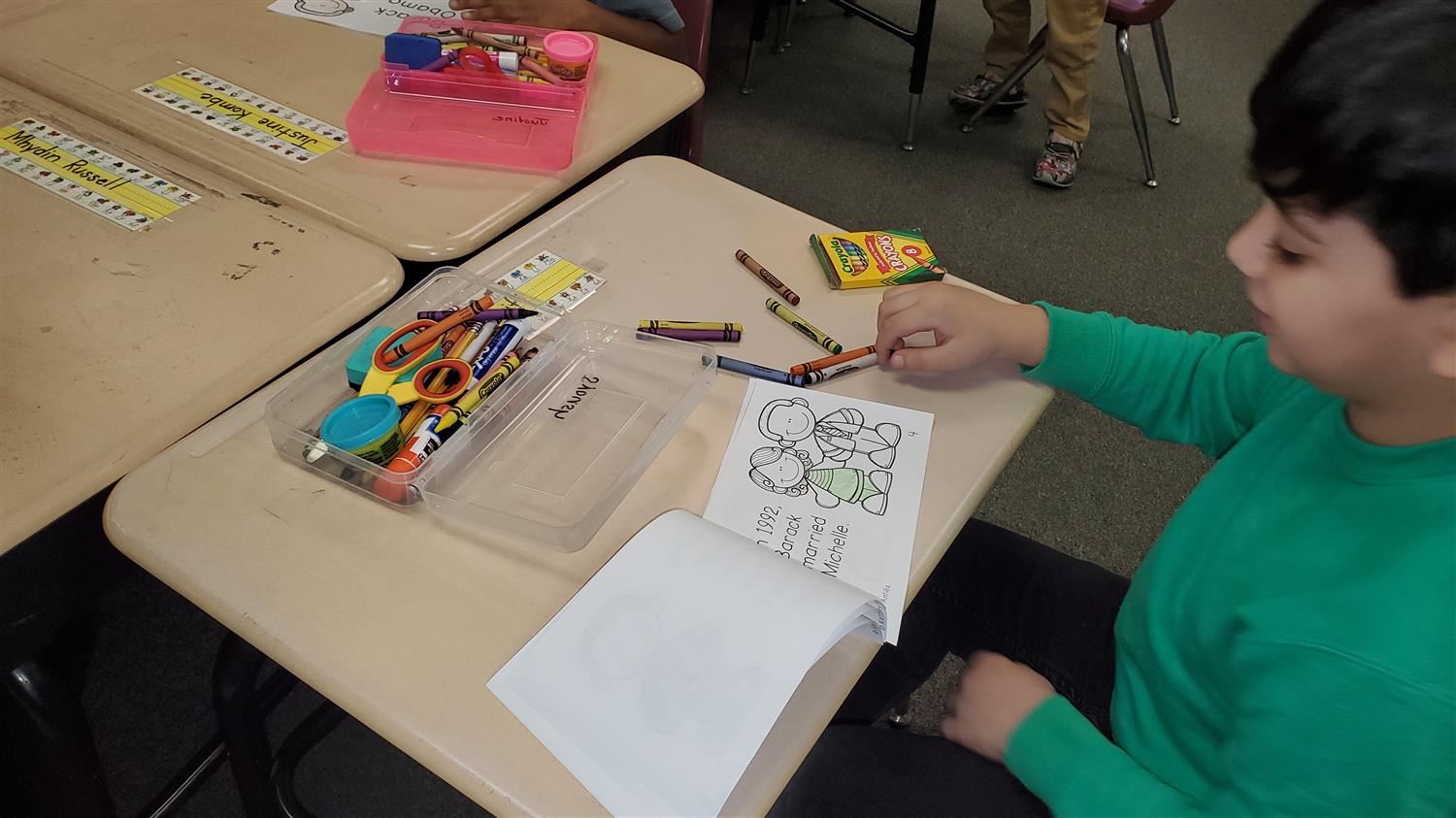 Student coloring a reader about Barack Obama.