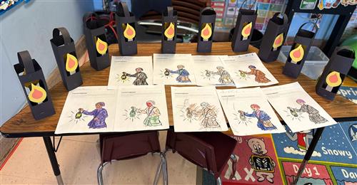 Photo shows pages colored by students featuring Harriet Tubman as well as lanterns made out of construction paper.