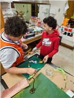 Two students construct a farm on paper to understand the impact of George Washington Carver.