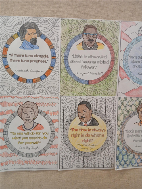 Photo shows student-colored posters featuring Black historical figures and impactful quotes.