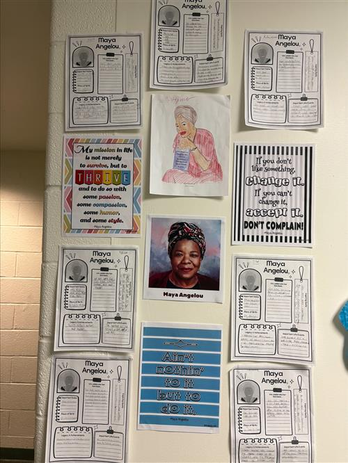 Several student-completed posters hung on a wall, featuring biographical information about, and quotes from, Maya Angelou.